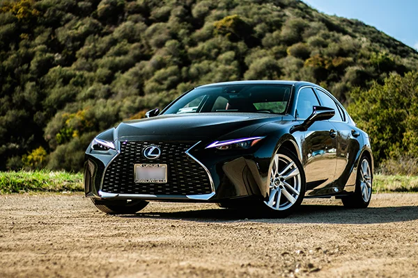 Black Lexus sedan parked on dirt road in canyon